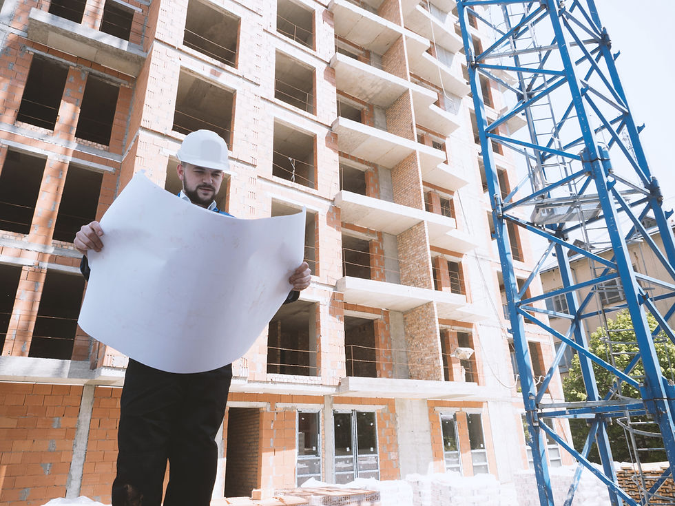 program manager reading design plans outside